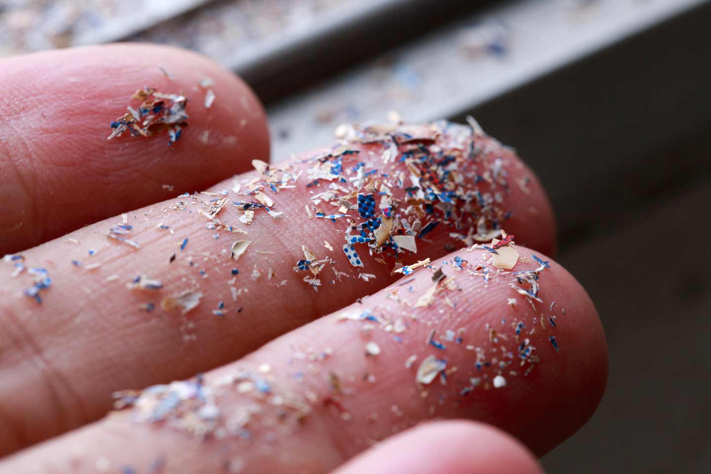 Close up of an hand with hundreds of specs of microplastics